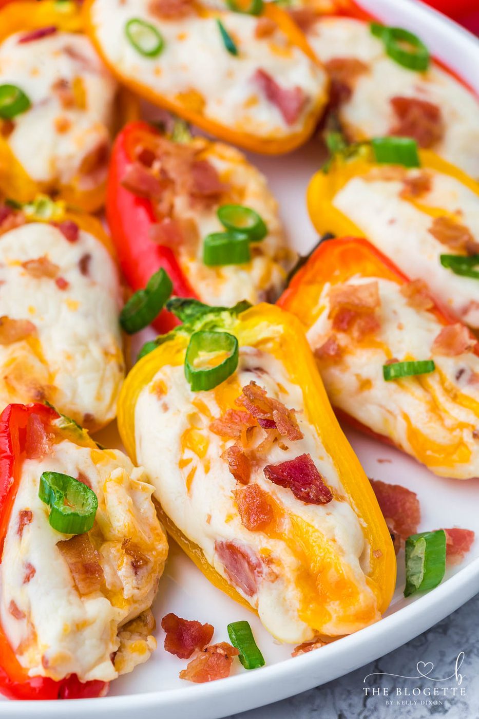 Cheesy Bacon Stuffed Mini Peppers! An straightforward appetizer idea for any gathering! Sweet mini peppers overflowing with cheese, bacon, and more!