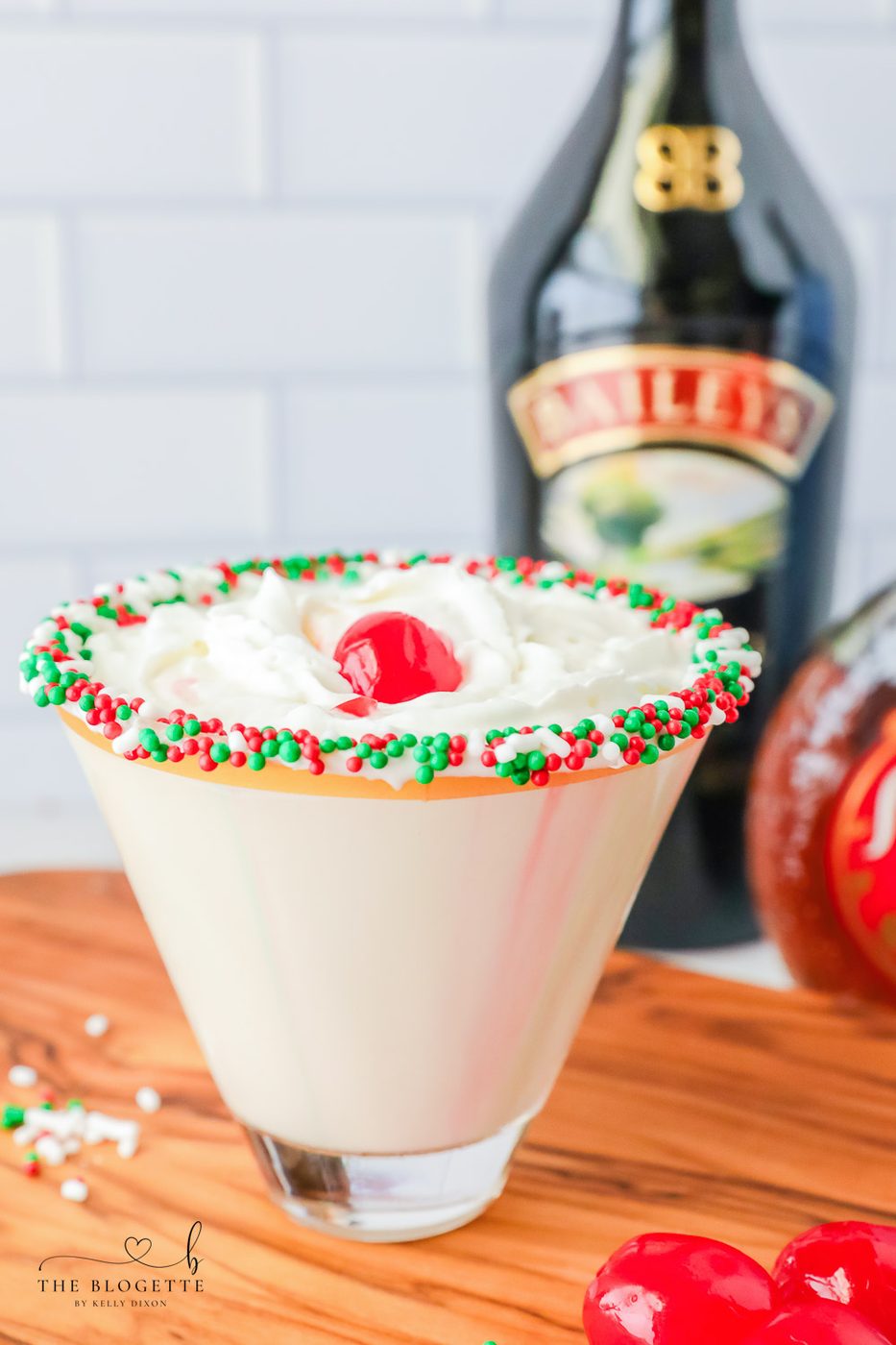 A sugar cookie cocktail for Christmas! Vanilla-rimmed martini glass filled with whipped cream vodka, Irish Cream, and Amaretto.