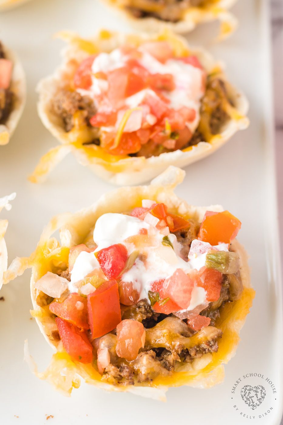 Taco Cups are a great appetizer or twist on Taco Tuesday! Beef and cheese stuffed inside bite-size flour tortillas and baked to perfection.