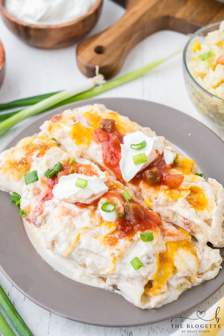 Creamy White Chicken Enchiladas made with flour tortillas, shredded chicken, cheese, sour cream, and more!