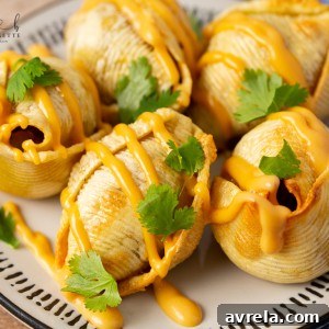 Air Fryer Taco Stuffed Shells recipe features seasoned ground beef and ooey-gooey cheese melted inside of slightly crips air-fried shells.