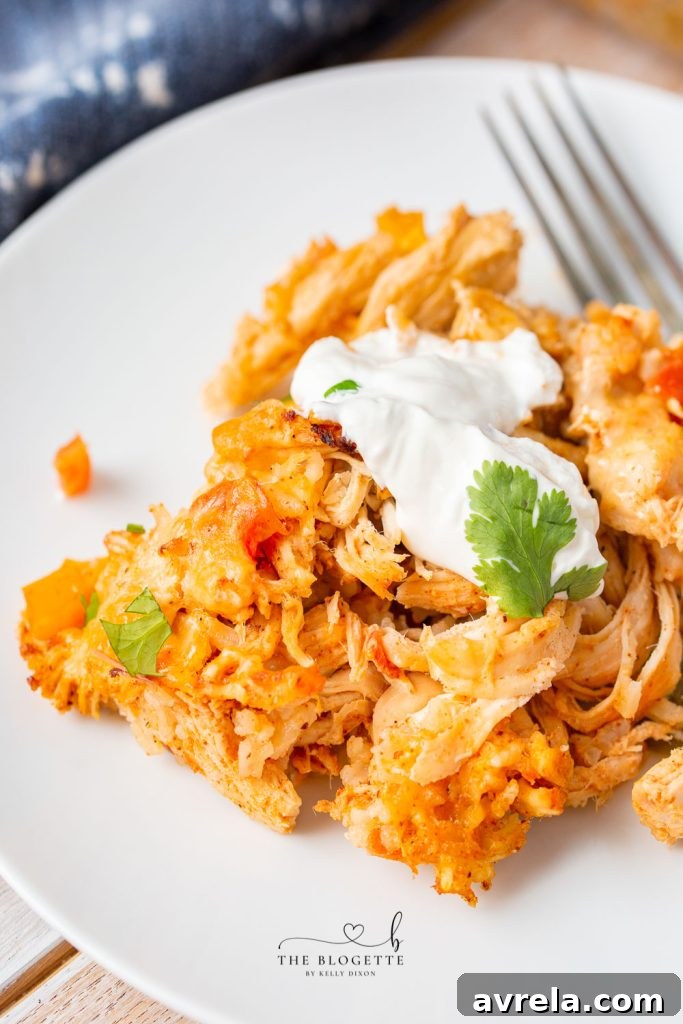 Zesty Chicken Fajita Bake 3 An overhead view of a hearty chicken fajita casserole in a baking dish, showcasing its rich texture and colorful ingredients like chicken, peppers, and cheese.