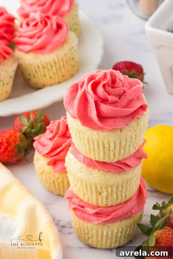 Closeup of fluffy, moist Strawberry Lemon Cupcakes with a generous swirl of strawberry frosting.