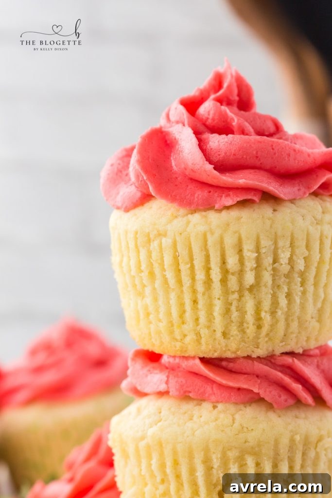 Beautifully frosted Strawberry Lemon Cupcakes arranged on a plate.
