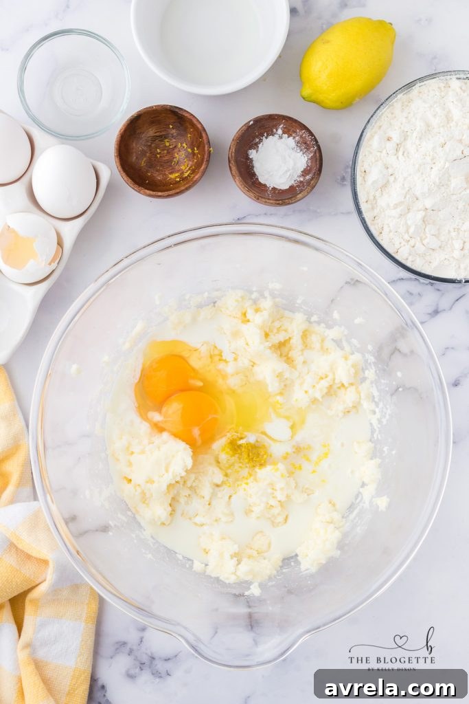 Ingredients for making lemon cupcakes, including butter, sugar, milk, eggs, lemon, baking powder, and flour.