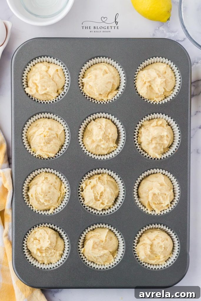 Baked cupcakes cooling in their liners.