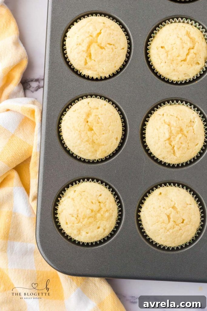 A freshly baked lemon cupcake, ready for frosting.