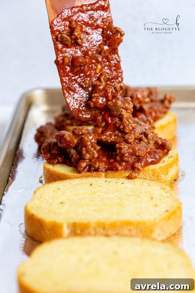 Sloppy Joe Toast 8 Sloppy Joe meat on garlic bread ready for cheese