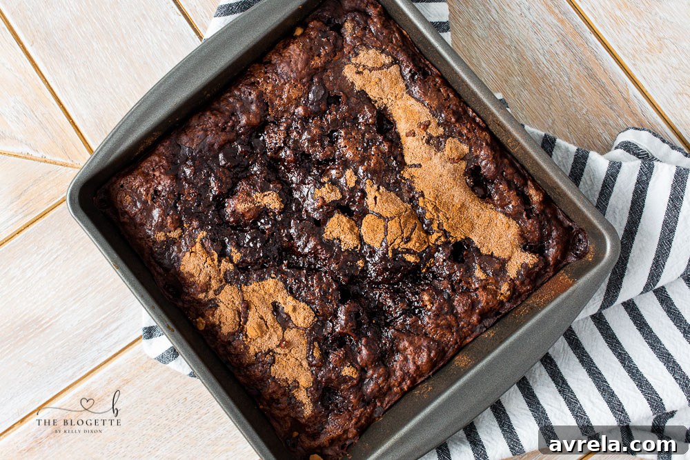Scoop of Hot Fudge Pudding Cake with melted vanilla ice cream