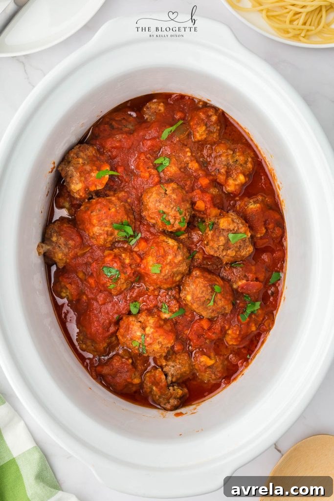 Slow Cooker Cheesy Stuffed Meatball Magic 10 Crock Pot Stuffed Meatballs served over spaghetti