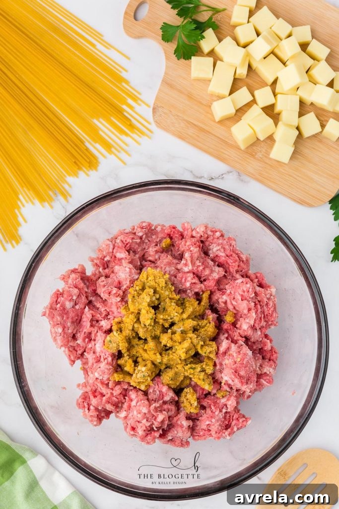 Slow Cooker Cheesy Stuffed Meatball Magic 8 Rolling meat mixture around mozzarella cube