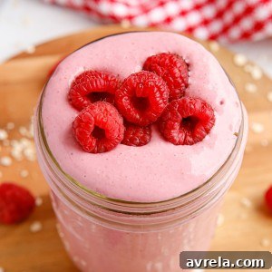 Ultra-smooth and creamy Raspberry Smoothie recipe! While it tastes like ice cream, this smoothie is a healthy way to sneak fruit and grains into your day!