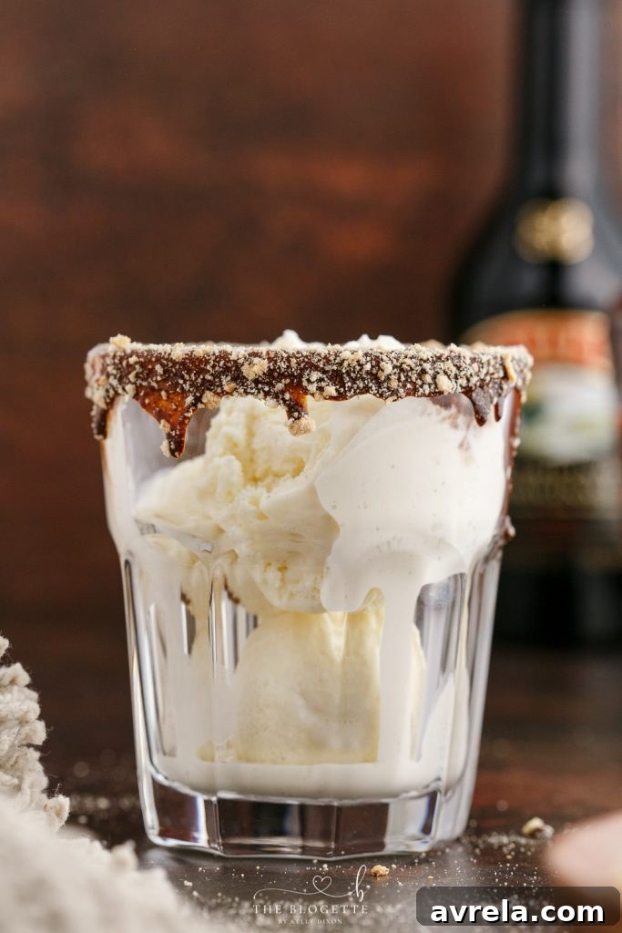 Baileys Toasted Smores Float 5 A glass being dipped into chocolate syrup to create a rim for the float.