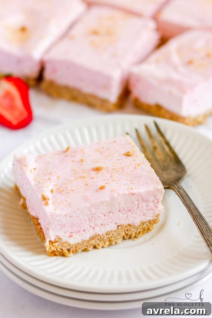 Strawberry Cheesecake Bars start with a graham cracker crust, a layer of cheesecake, and then a no-bake strawberry cheesecake layer.