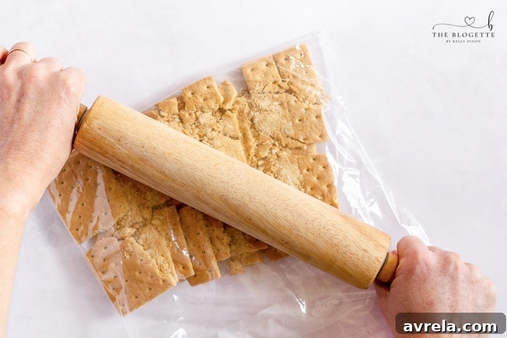 Graham crackers being crushed into fine crumbs for the crust.