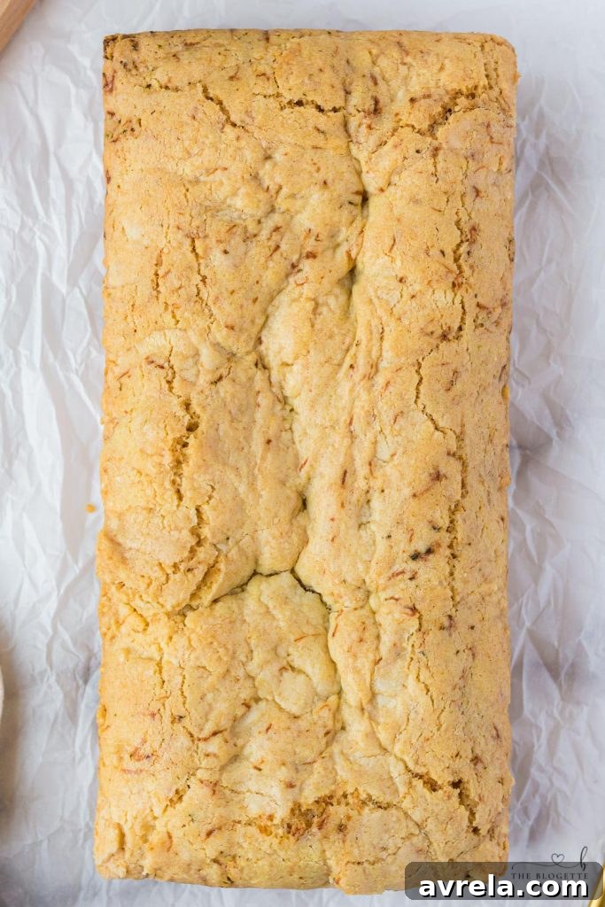 A perfectly baked loaf of Amish Zucchini Bread, sliced and ready to be served, showcasing its moist texture.
