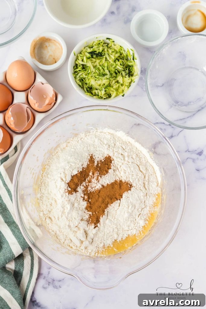 Dry ingredients being gently whisked into the wet mixture, ensuring a smooth batter for the quick bread.