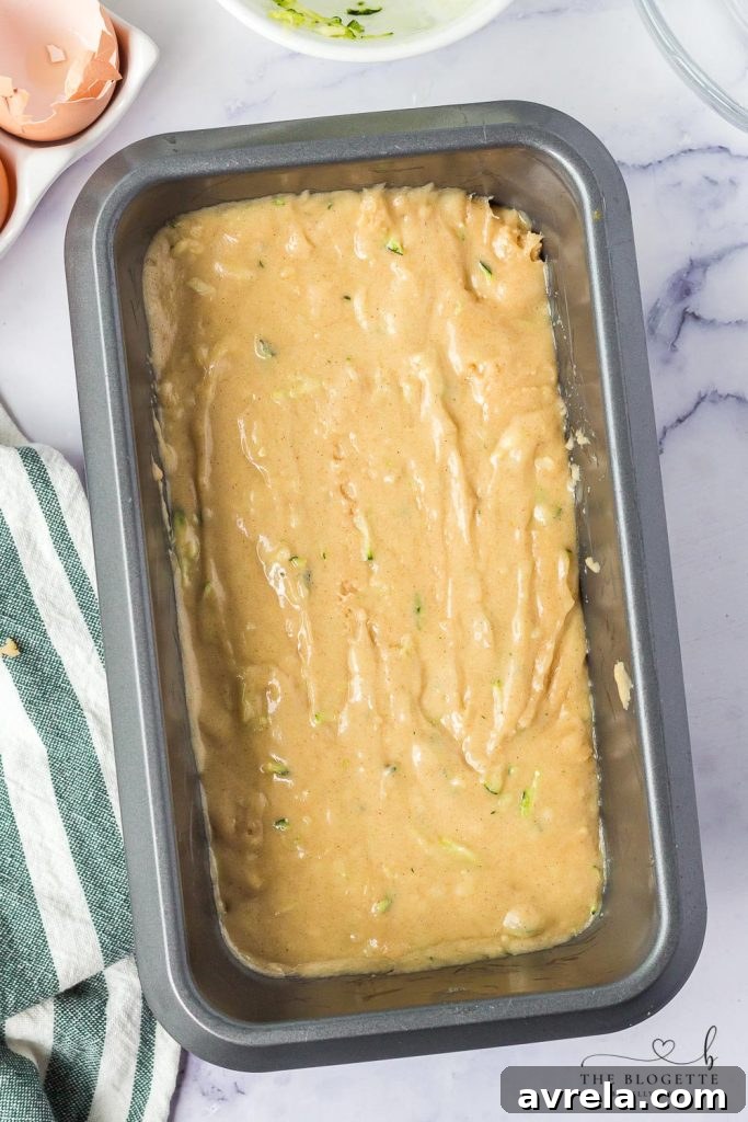 Amish Zucchini Bread batter poured into a loaf pan, ready for baking.