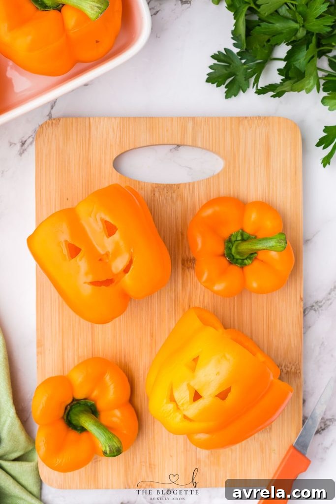 Orange bell peppers carved into jack o lantern pumpkins for Halloween!