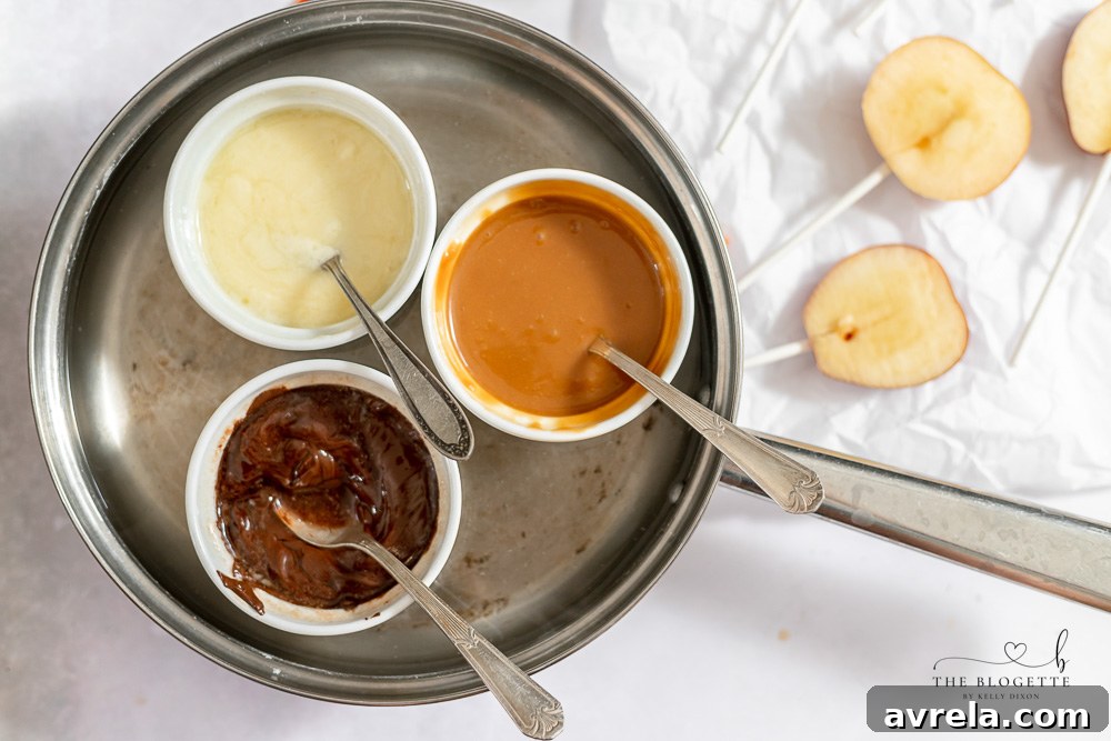 Bowls of melted caramel, chocolate, and white chocolate, ready for dipping.