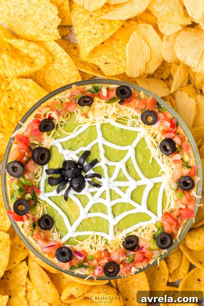 A close-up of Spider Web 7 Layer Dip in a round dish, perfect for Halloween entertaining.