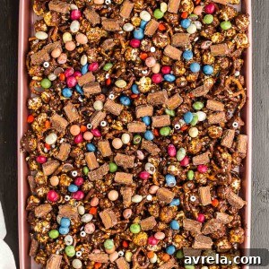 Fright Night Fuel 9 Halloween Snack Mix is chocolate caramel popcorn combined with tasty Halloween treats and salty pretzels. A Halloween party treat!