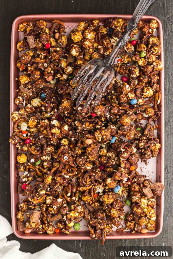 Fright Night Fuel 8 A close-up of the delicious Halloween Snack Mix chunks in a festive bowl, ready for serving at a party.