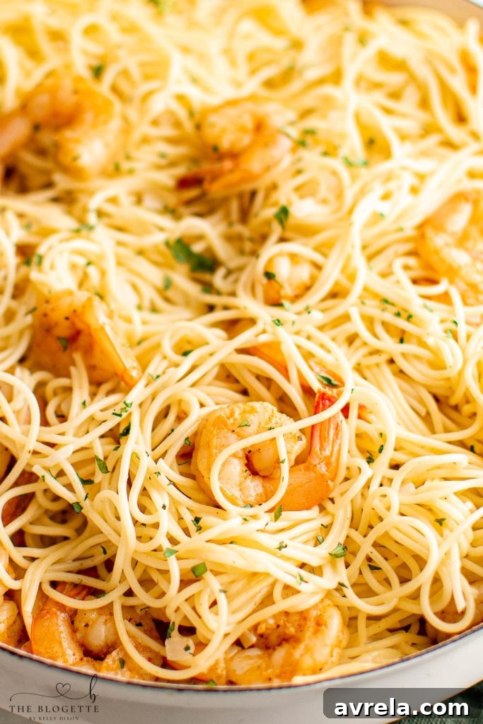 Lemon Garlic Butter Scampi Pasta 3 Two plates of Garlic Butter Shrimp Scampi Pasta, garnished with fresh parsley, ready to be enjoyed.