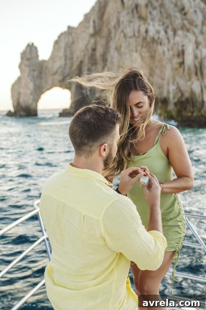 Engagement ring sparkling against the backdrop of the iconic Cabo Arch.