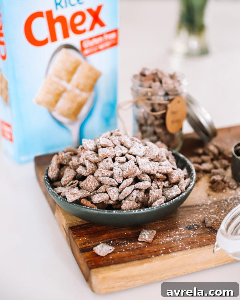 Close-up of the Muddy Buddies mixture before being coated in powdered sugar, showing the chocolate and peanut butter coating.