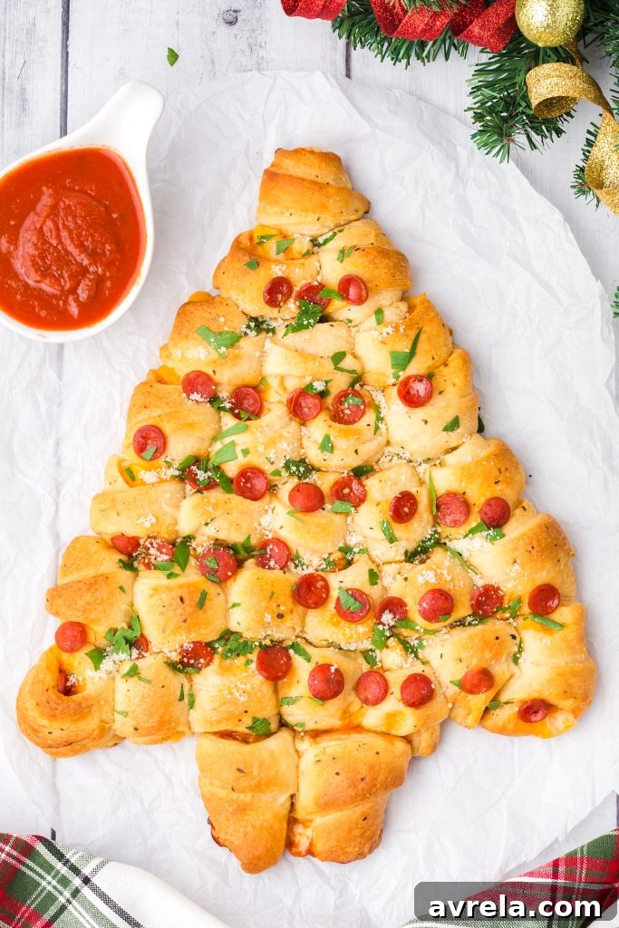Christmas Tree Tear and Share Bread 2 A golden-brown pepperoni and cheese Christmas Tree Pull Apart Bread, freshly baked and ready to serve, a perfect holiday appetizer for family and friends.