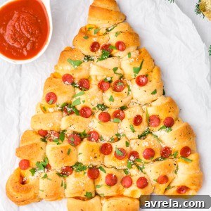 A pepperoni and cheese Christmas Tree Pull Apart Bread is the perfect Christmas appetizer! Easy, versatile, and makes everyone smile!