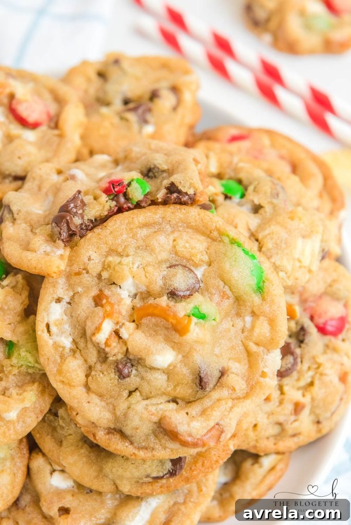 Kitchen Sink Christmas Cookies are sweet-and-salty, chewy-and-gooey cookies with M&M's, chocolate chips, pretzels, marshmallows, potato chips... everything but the kitchen sink! 