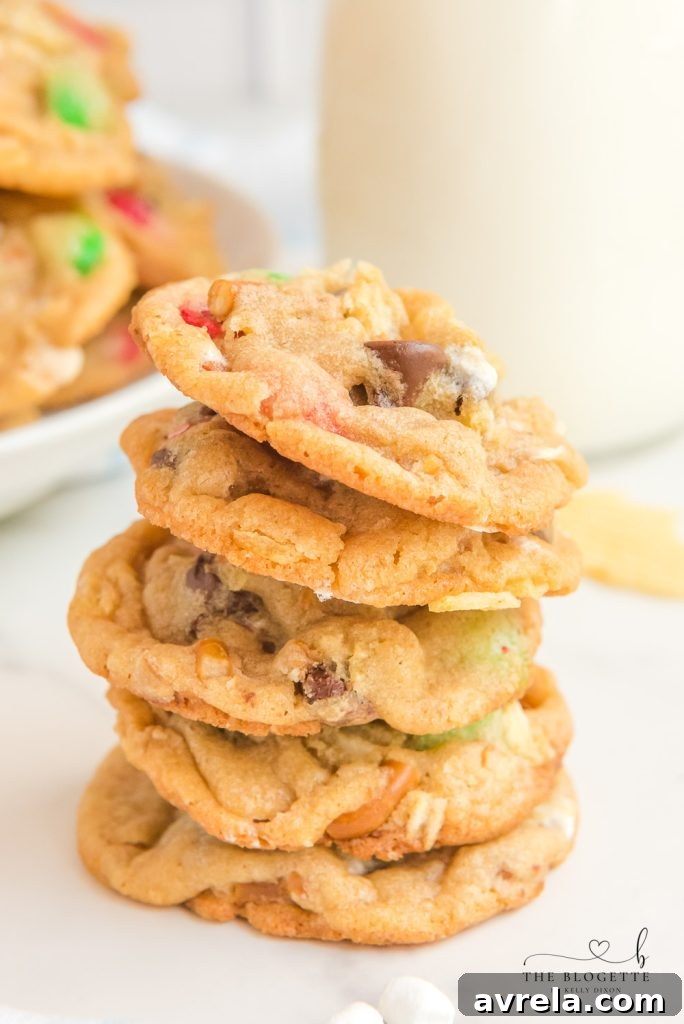 Kitchen Sink Christmas Cookies are sweet-and-salty, chewy-and-gooey cookies with M&M's, chocolate chips, pretzels, marshmallows, potato chips... everything but the kitchen sink!