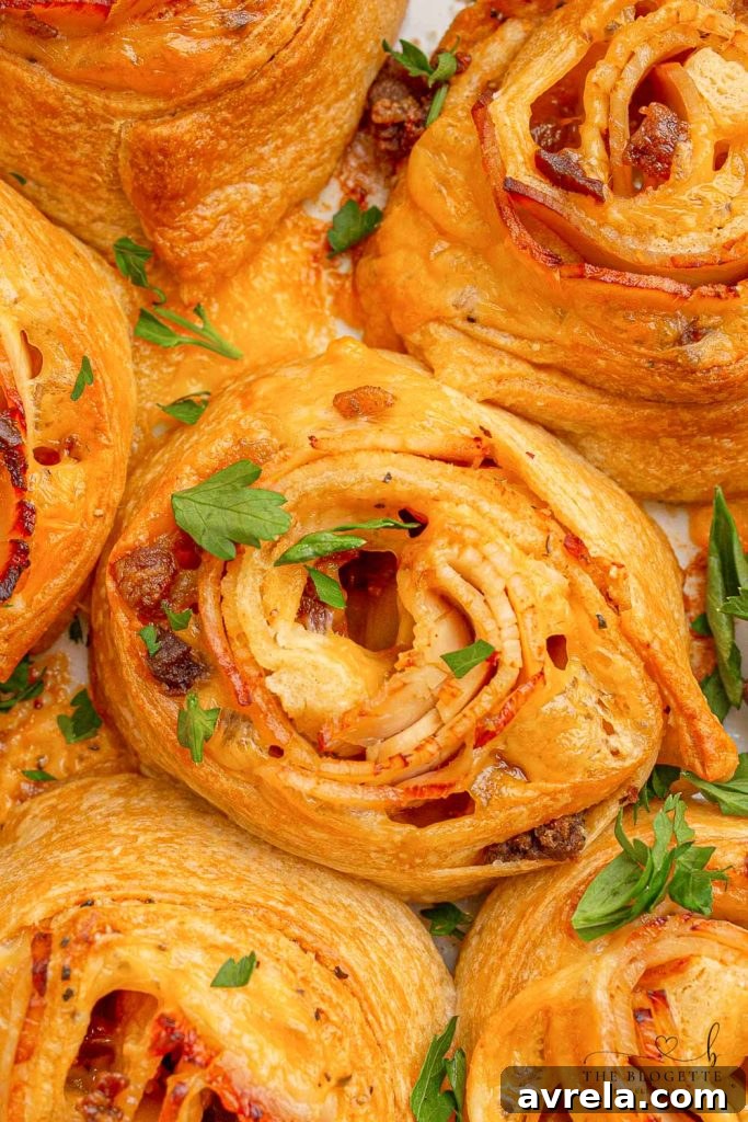 Baked Turkey and Cheese Rolls with melted cheese, bacon, and turkey, covered in a garlic buttery glaze. An irresistible party appetizer.