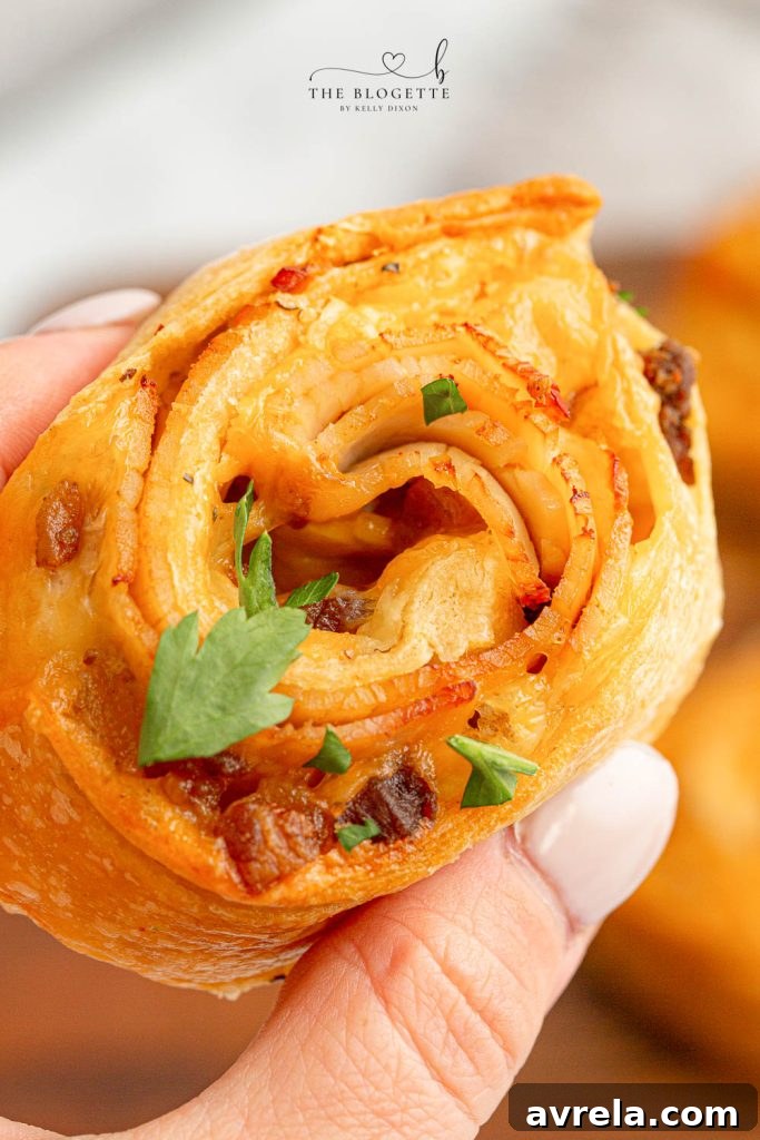 Baked Turkey and Cheese Rolls, glistening with garlic butter glaze, perfect for any party.
