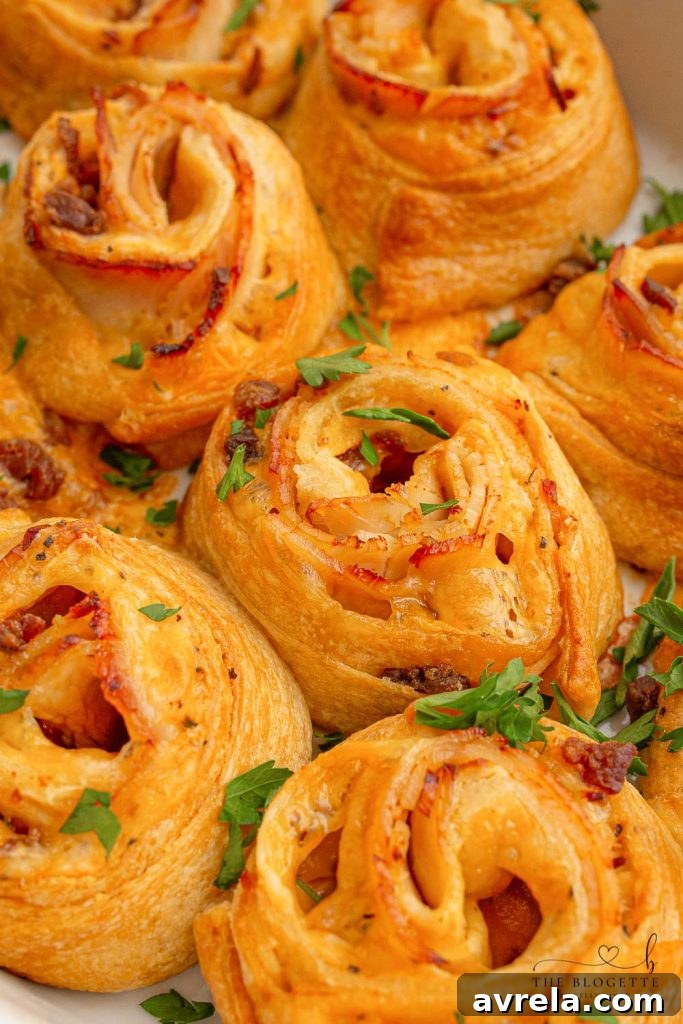 Baked Turkey and Cheese Rolls featuring melted cheese, crispy bacon, and tender turkey, all infused with a savory garlic butter glaze. An ideal party appetizer.