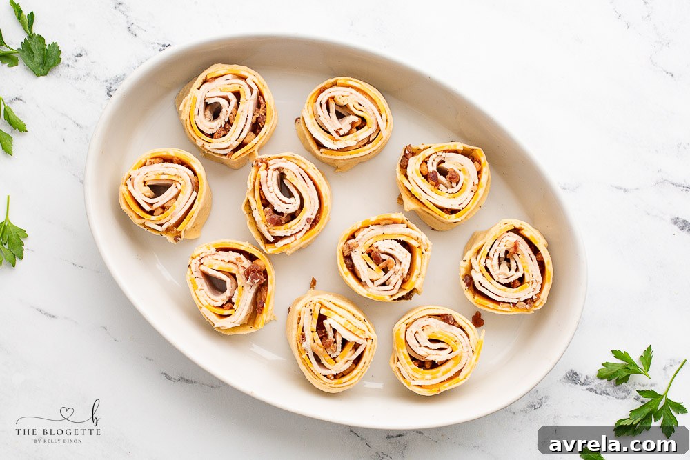 A platter of Baked Turkey Club Party Rolls, perfect for any gathering.