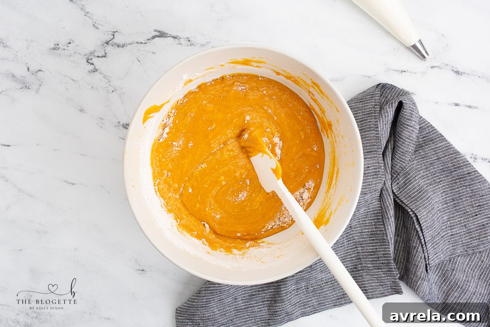 Smooth pumpkin pie cupcake batter in a mixing bowl, perfectly combined and ready for baking.