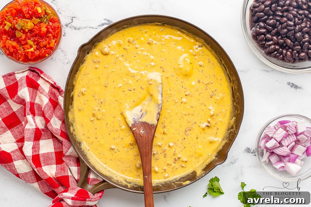 All the queso dip ingredients mixed together in a skillet, heated through and ready to serve.