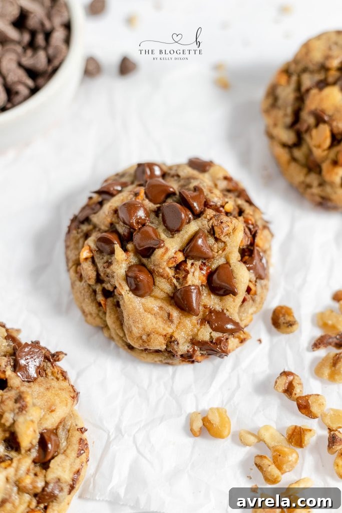 Close-up of freshly baked, warm, soft, and thick chocolate chip cookies, showcasing their bakery-style texture.