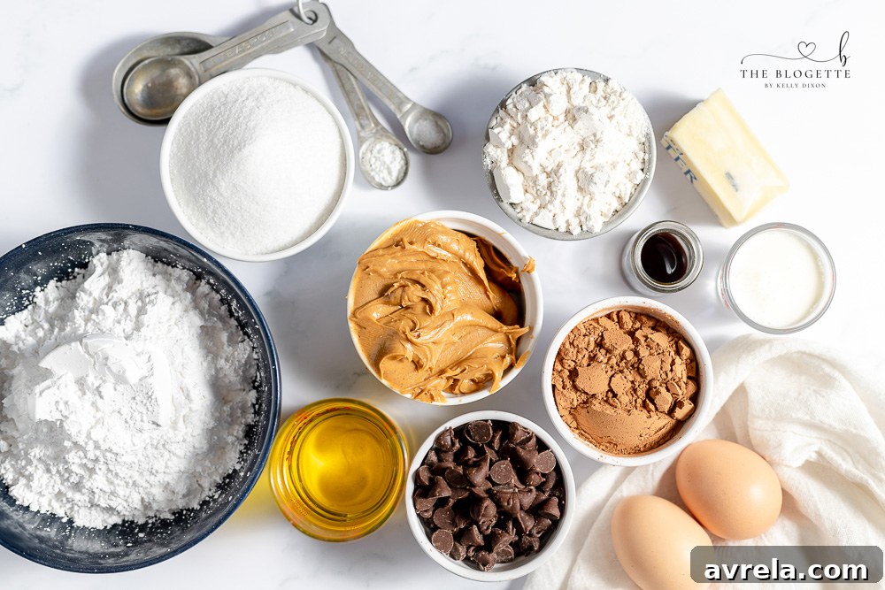 Ingredients laid out for making Buckeye Brownies including cocoa, flour, sugar, eggs, butter, peanut butter, and chocolate chips