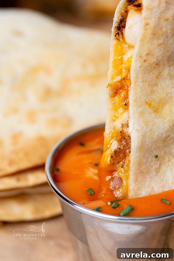 Delicious quesadilla slices garnished with fresh chives and served with dipping sauces