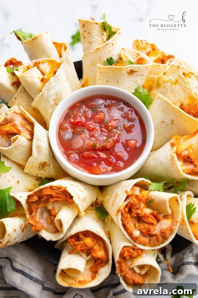 A beautifully baked Blooming Burrito Ring, golden and cheesy, served with a vibrant bowl of salsa in the center, ready to be enjoyed as a festive appetizer.