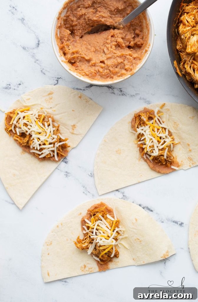 A series of mini burrito cones, each perfectly rolled and filled with a savory mix of chicken, beans, and cheese, ready for assembly into the blooming ring.