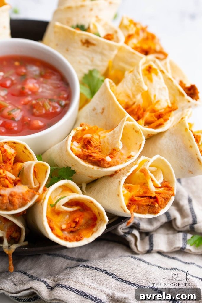 The fully assembled and garnished Blooming Burrito Ring, presented on a round board with multiple dipping sauces, highlighting its appeal as a shared appetizer.