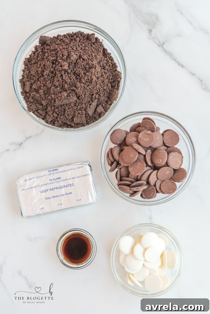 A display of the few simple ingredients needed for making Oreo Truffles: Oreo cookies, cream cheese, vanilla extract, chocolate melting wafers, and white chocolate candy melts.