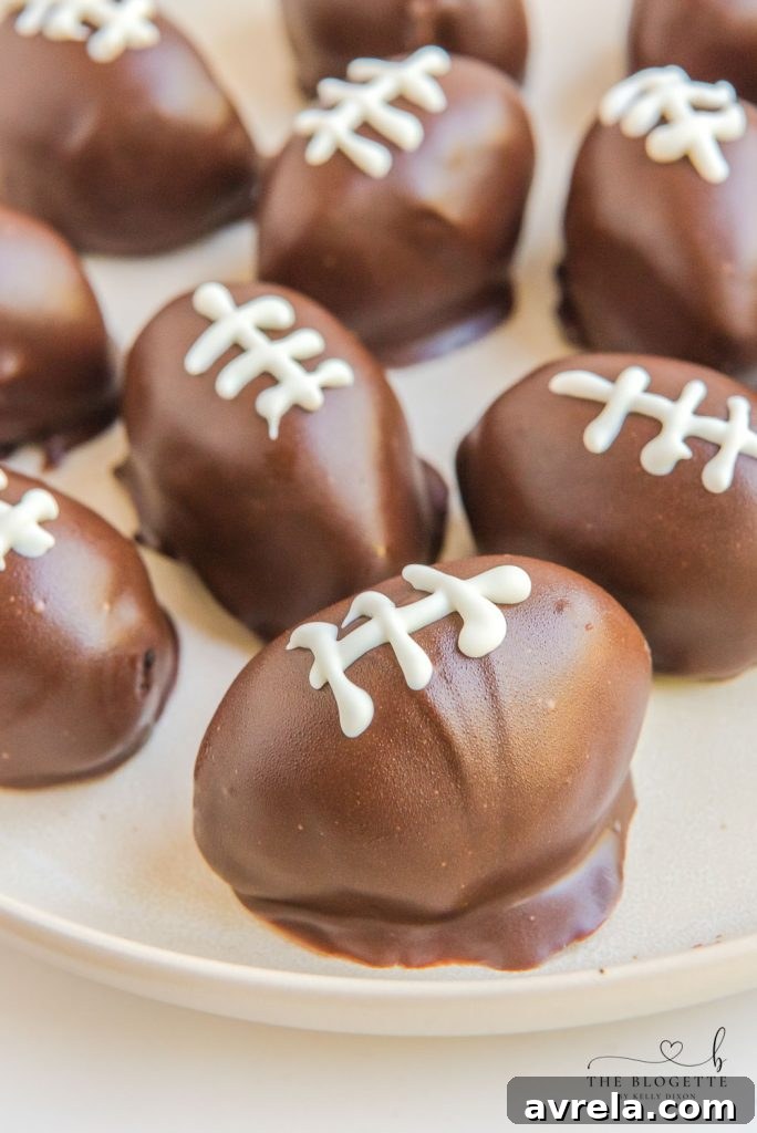 Adding white chocolate laces to football-shaped Oreo Truffles, making them perfect for game day parties.