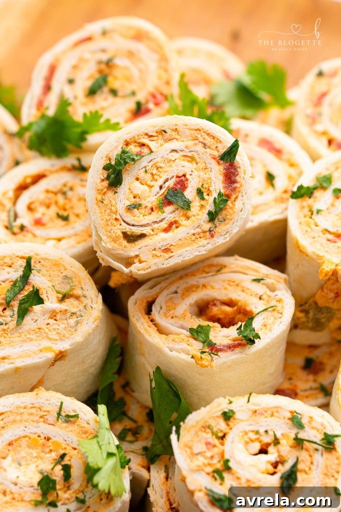Delicious Chicken Enchilada Roll Ups on a platter, ready to serve as the perfect party appetizer.