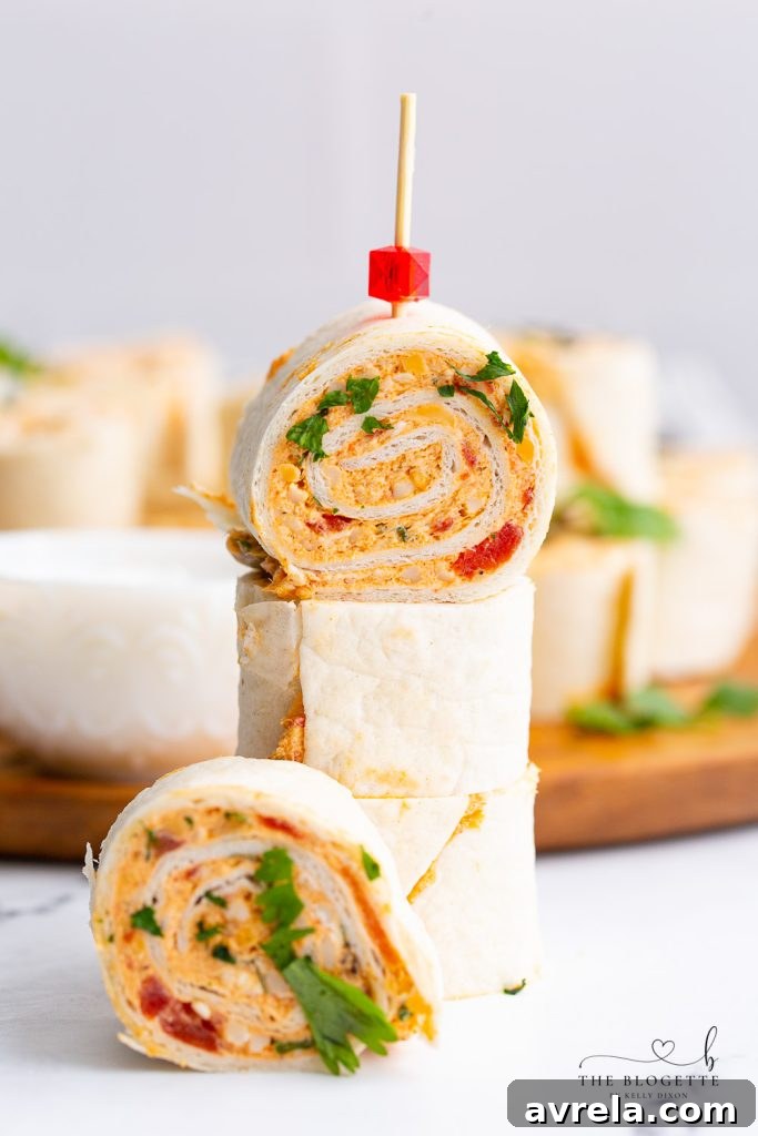 A beautifully presented platter of Chicken Enchilada Roll Ups, garnished with fresh cilantro and ready to be enjoyed at a party or casual gathering.